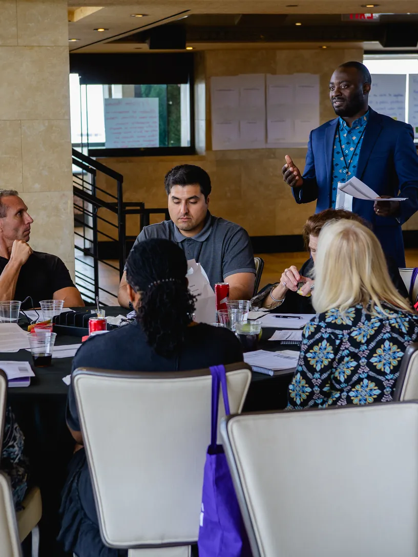An independent water-policy expert briefing delegates at a breakout table